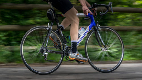 Low section of man riding bicycle