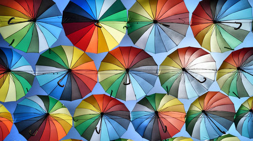 Low angle view of multi colored umbrellas at market stall