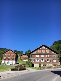 Houses against clear blue sky