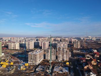 High angle view of buildings against blue sky