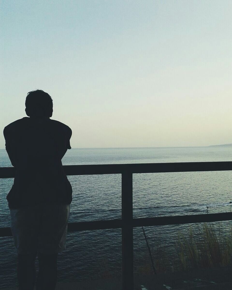 water, sea, horizon over water, clear sky, silhouette, copy space, tranquil scene, tranquility, scenics, beauty in nature, nature, sunset, standing, sky, idyllic, rear view, calm, pier