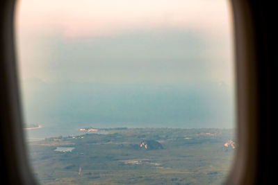 Scenic view of landscape seen through airplane window