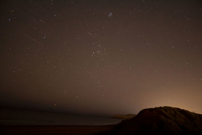 Low angle view of mountain against sky at night