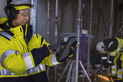 Engineer at building site using digital tablet