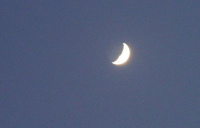 Low angle view of moon against clear sky at night