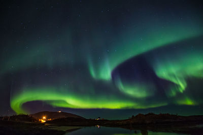 Low angle view of aurora polaris against sky at night