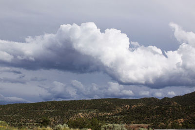 Countryside landscape against cloudy sky