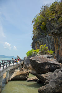 Rock formations by sea against sky