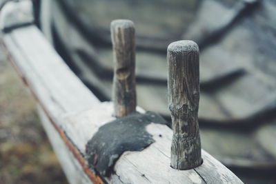 Close-up of rusty chain on wooden post