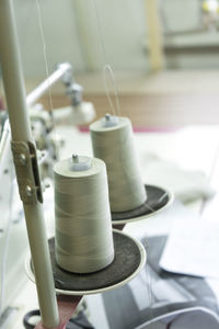 Close-up of a two spools of thread on the industrial sewing machine.