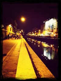 Illuminated city street at night