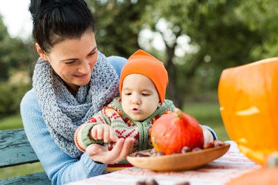 Mother and girl relaxing in traditional clothing outdoors