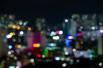 Defocused image of illuminated city at night