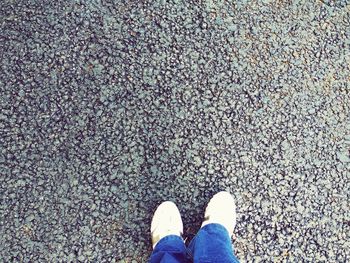 Low section of man standing on road