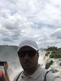 Portrait of man wearing sunglasses against sky