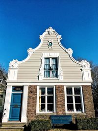 Low angle view of building against clear blue sky