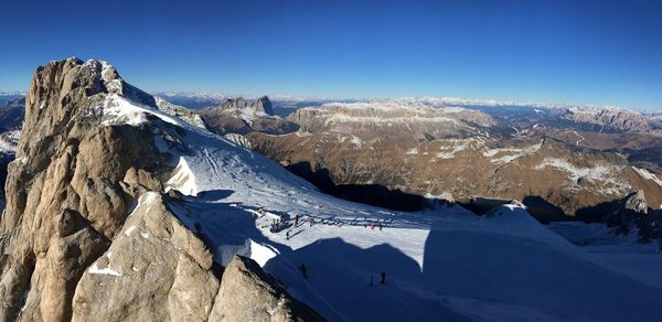 Scenic view of snowcapped mountains against clear blue sky