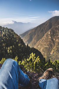 Rear view of people on mountain against sky