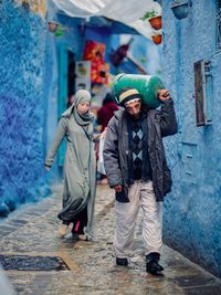 Full length portrait of young couple standing in snow