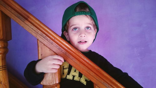 Boy standing at railing on staircase