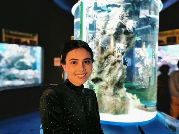 Portrait of smiling young woman standing in store