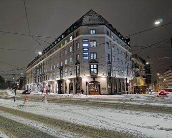 Buildings in city during winter at night