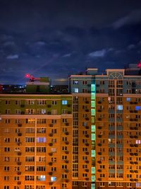 High angle view of buildings against sky at night