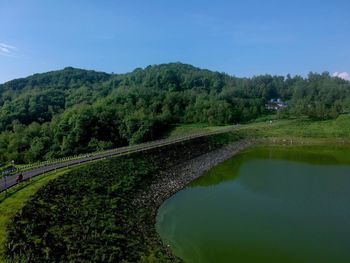 Scenic view of green landscape against sky