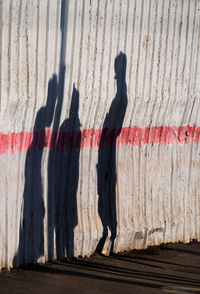 Shadow of people on corrugated metal