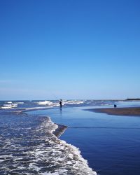 Scenic view of sea against clear blue sky