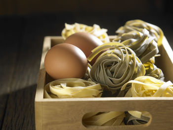 Directly above shot of tagliatelle pasta in crate on table