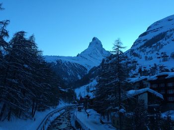 High angle view of river amidst snowcapped mountains at dusk