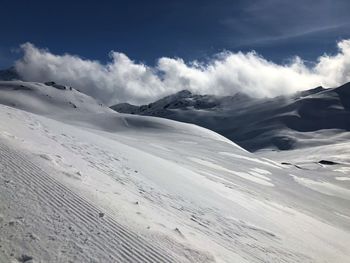 Scenic view of snow covered mountains against sky