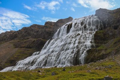 Huge waterfall running down from a cliff in iceland