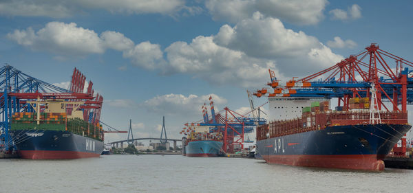 View of commercial dock against cloudy sky