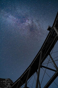 Low angle view of tower against sky at night