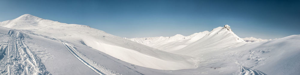 Scenic view of snowcapped mountains against sky