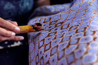 Midsection of man holding cigarette