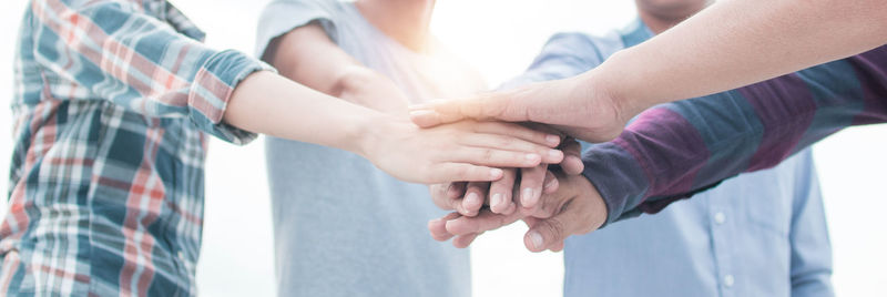 Midsection of couple holding hands