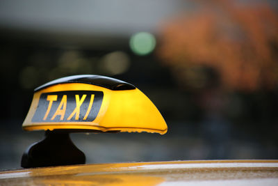 Close-up of yellow taxi sign