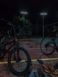 Bicycles parked on street at night