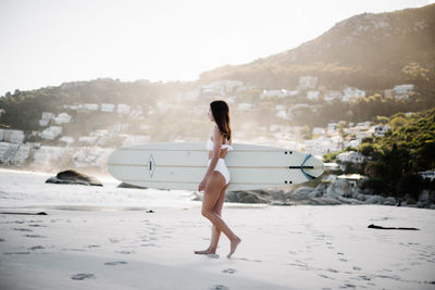 Full length of woman standing on land against sky