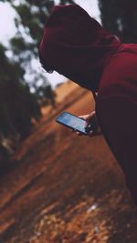 Close-up of man holding mobile phone
