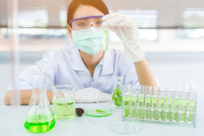 Close-up of female scientist experimenting in laboratory