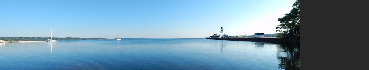 Scenic view of sea against clear blue sky