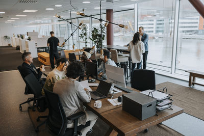 Multiracial male and female colleagues working in corporate office