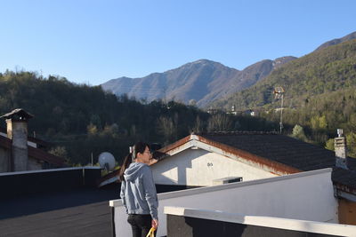 Man standing on mountain against clear sky