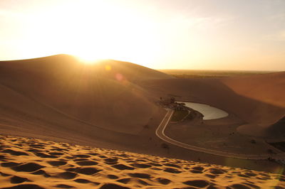 Scenic view of desert against sky during sunset