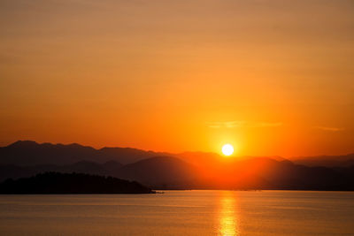 Scenic view of lake against romantic sky at sunset