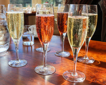 Close-up of champagnes served on wooden table